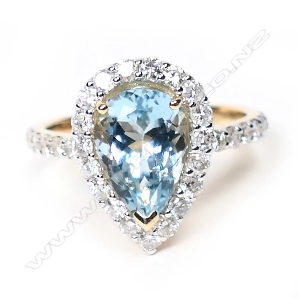 A 14ct gold, aquamarine and diamond halo ring, Image 1++
