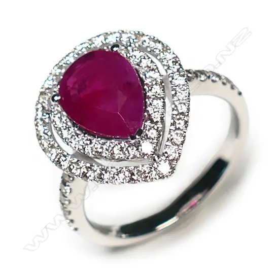 A 14ct white gold ruby and diamond double halo ring,