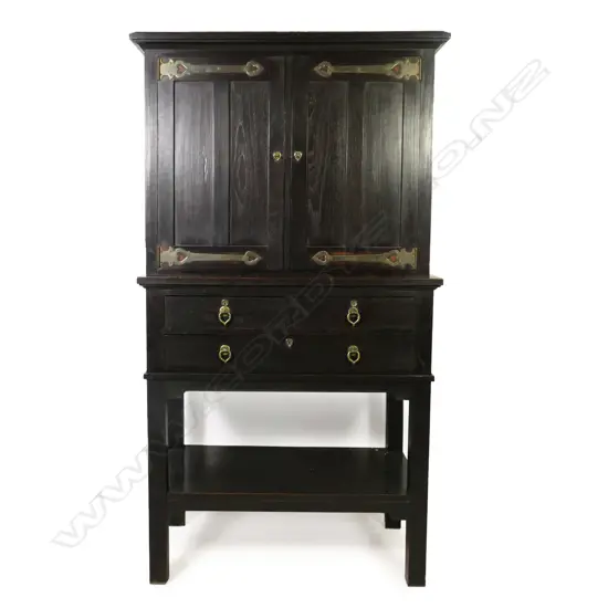 An Edwardian Arts & Crafts ebonized oak cabinet on stand