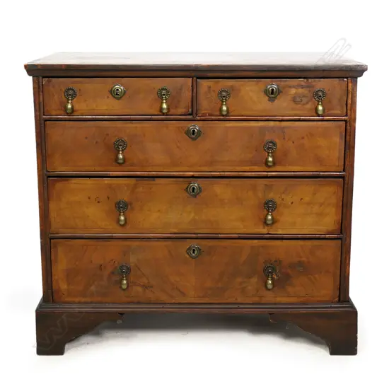 An early Georgian walnut veneer chest of five drawers