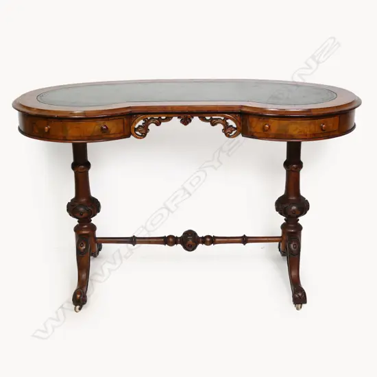 A Victorian tooled leather topped lady's desk of kidney shape