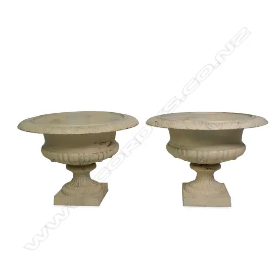 A pair of cast iron garden urns,