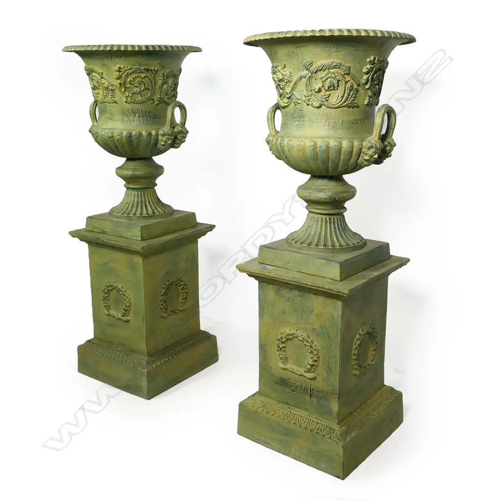 A pair of cast iron garden urns on plinths, Image 1++