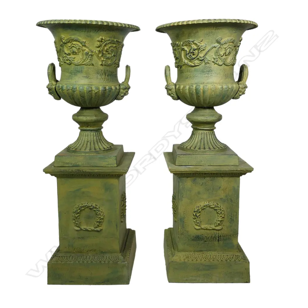 A pair of cast iron garden urns on plinths, Image 1++