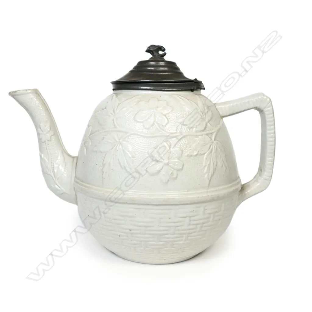 A salt glaze china Victorian period teapot, with pewter mounted cover and decorated with prunus and basket weave. Unmarked. W.230mm. Image 1++