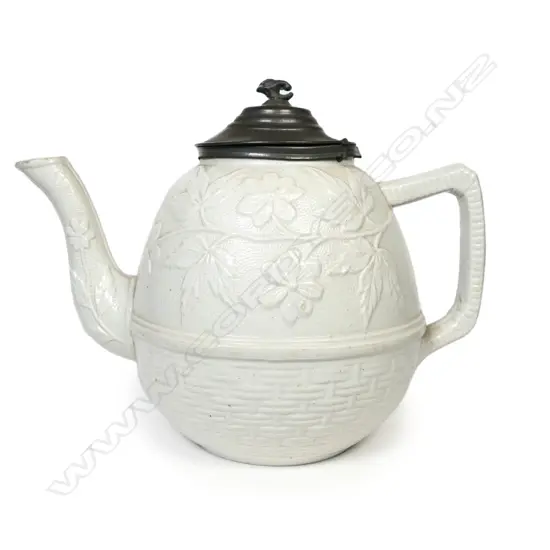 A salt glaze china Victorian period teapot, with pewter mounted cover and decorated with prunus and basket weave. Unmarked. W.230mm.
