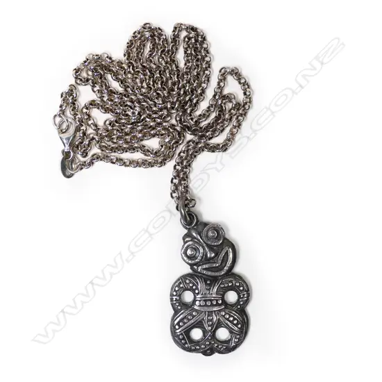 A c1940 cast silver hei tiki pendant,