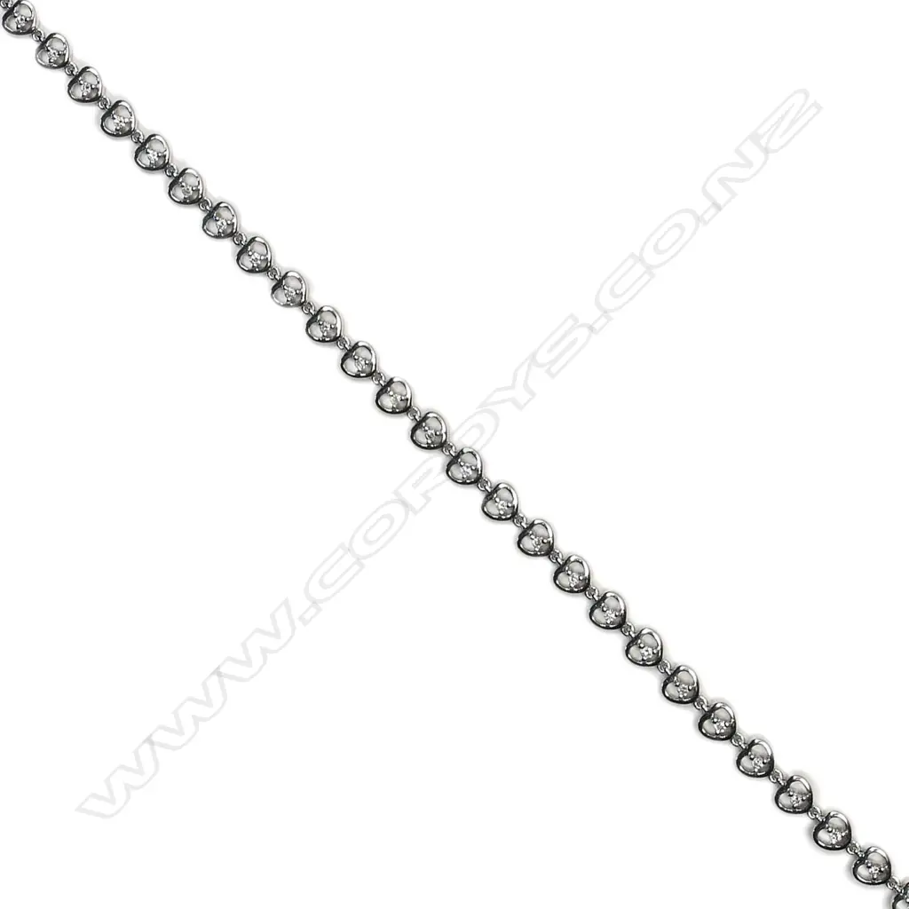 An 18ct white gold and diamond bracelet, the twenty-nine round brilliant cut diamonds individually set to heart shaped links. TDW 0.36ct. Image 1++