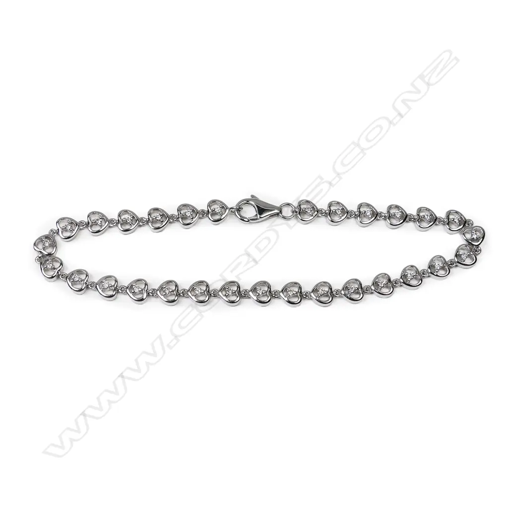 An 18ct white gold and diamond bracelet, the twenty-nine round brilliant cut diamonds individually set to heart shaped links. TDW 0.36ct. Image 1++