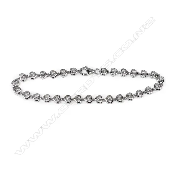 An 18ct white gold and diamond bracelet, the twenty-nine round brilliant cut diamonds individually set to heart shaped links. TDW 0.36ct.