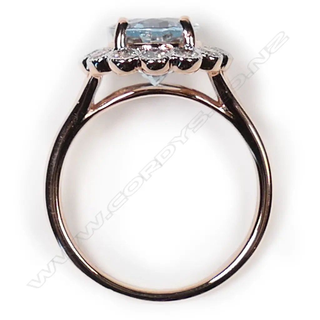 A 14ct rose gold, aquamarine and diamond halo ring, Image 1++