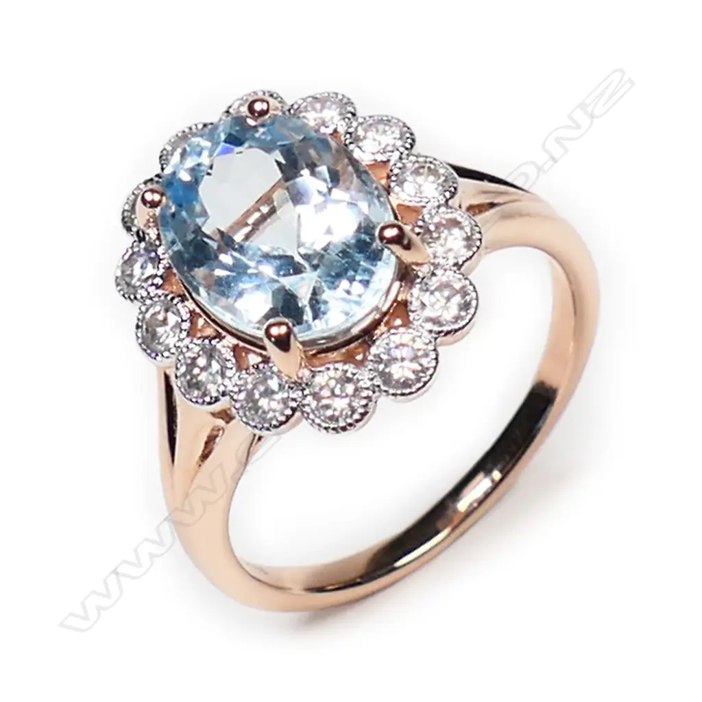 A 14ct rose gold, aquamarine and diamond halo ring, Image 1++