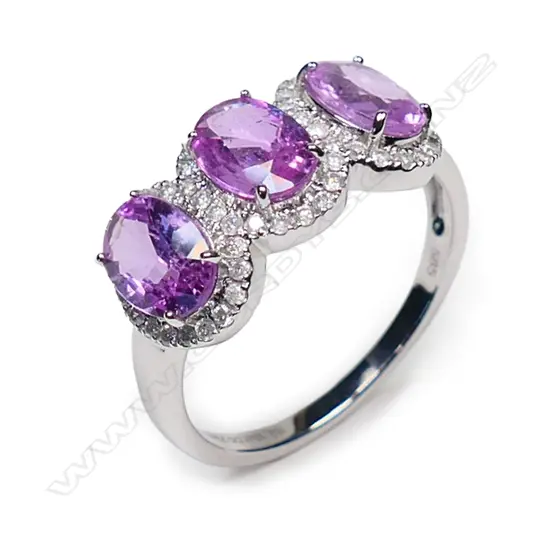 A 14ct white gold pink sapphire and diamond trilogy ring,