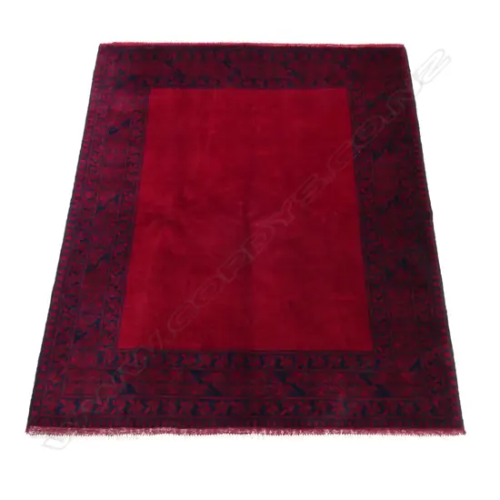 A Turkman rug, decorated with traditional geometric medallions,