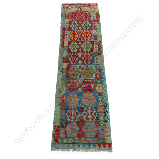 A muliti-coloured kilim runner,