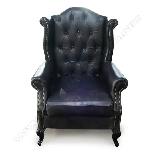 A leather wing back armchair,