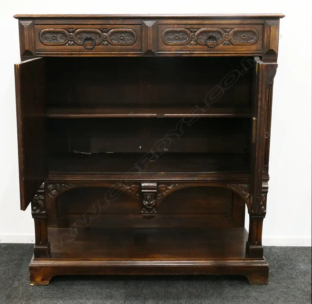 A 19thC oak Continental sideboard, two half drawers over two elaborately carved doors, shelf to base with conforming carved detail. 1280 x 500 x 1400mm. Image 1++