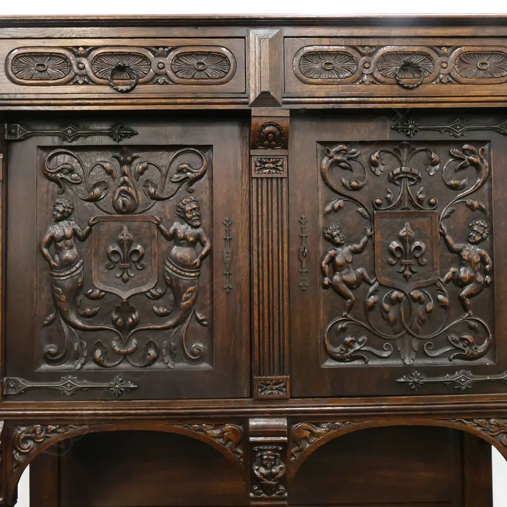 A 19thC oak Continental sideboard, two half drawers over two elaborately carved doors, shelf to base with conforming carved detail. 1280 x 500 x 1400mm. Image 1++