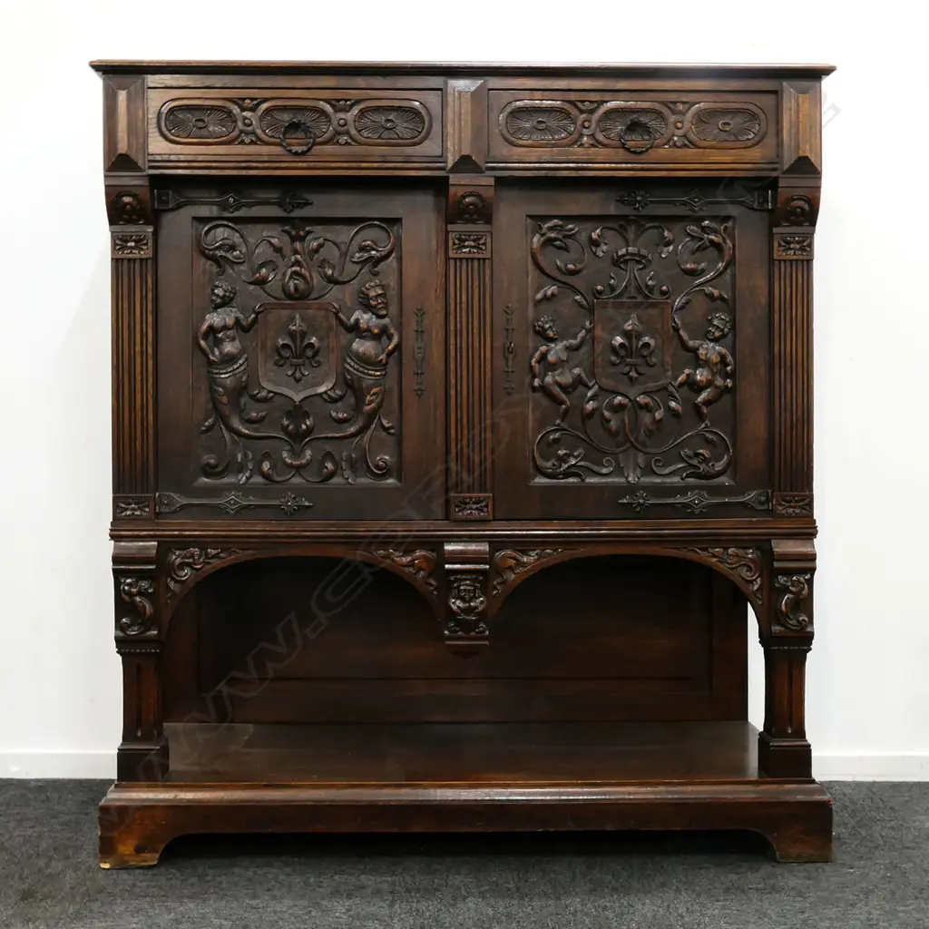 A 19thC oak Continental sideboard, two half drawers over two elaborately carved doors, shelf to base with conforming carved detail. 1280 x 500 x 1400mm. Image 1++
