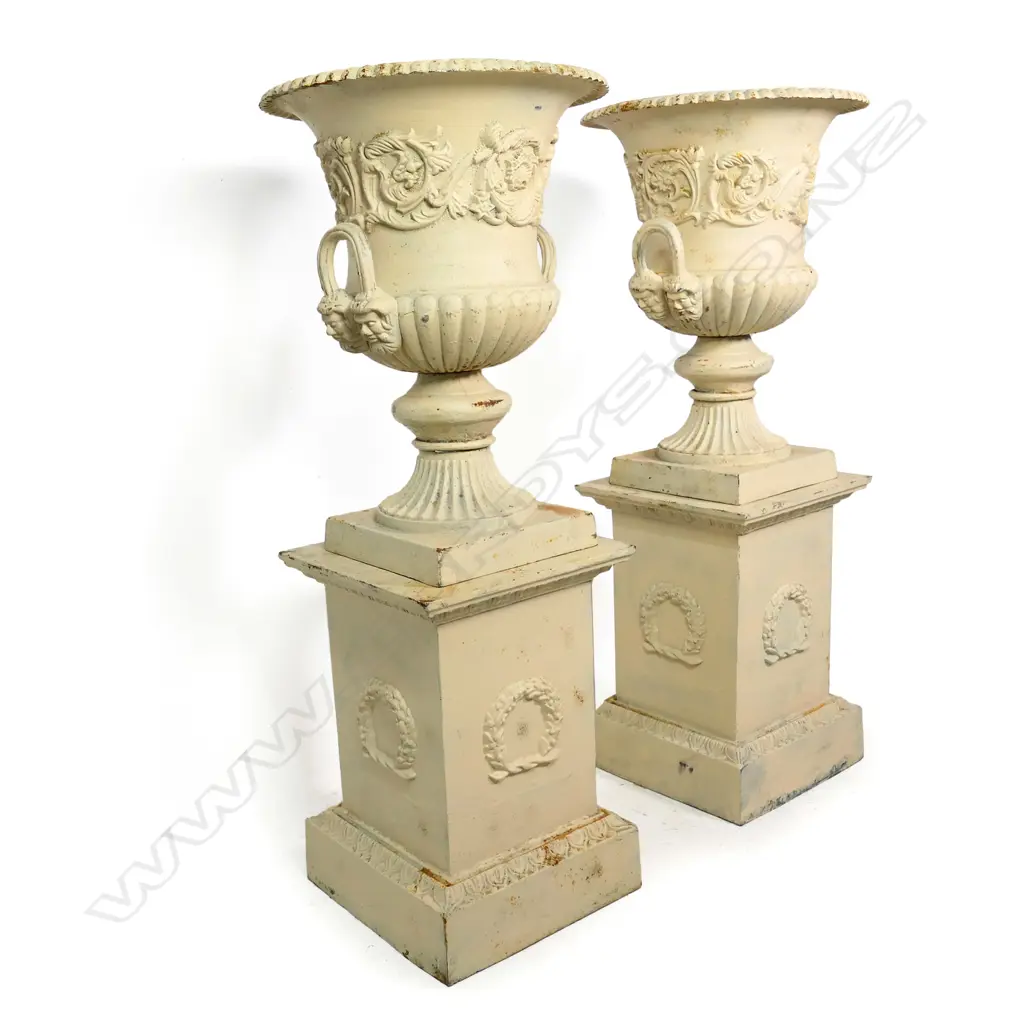 A pair of cast iron garden urns on plinths, Image 1++
