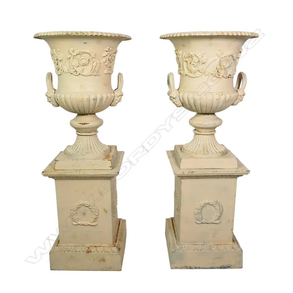 A pair of cast iron garden urns on plinths, Image 1++