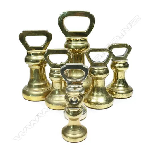 A harlequin set of seven brass Avery bell weights,