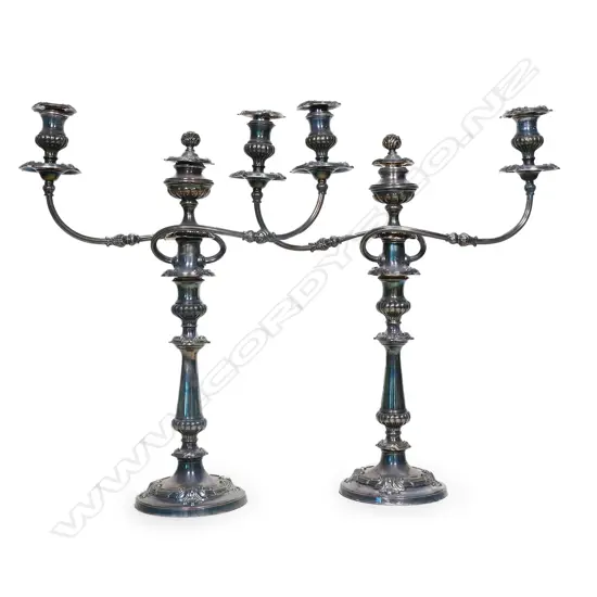 A pair of early 20thC silver on copper table candelabra