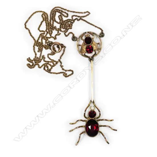 A vintage 9ct gold and garnet spider and fly pendant,