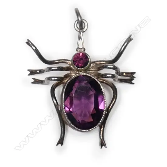A small vintage silver and amethyst spider pendant,