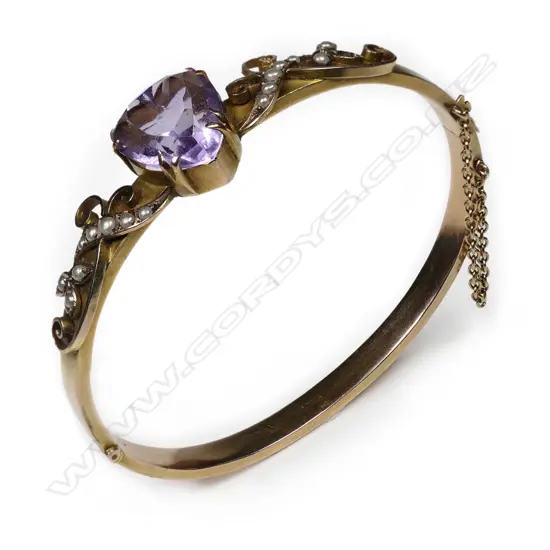 An Edwardian 9ct gilded rose gold snap bangle,