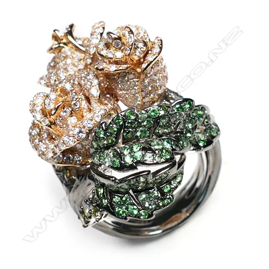 An impressive 18ct rose, white and black gold diamond and tsavorite garnet dress ring,