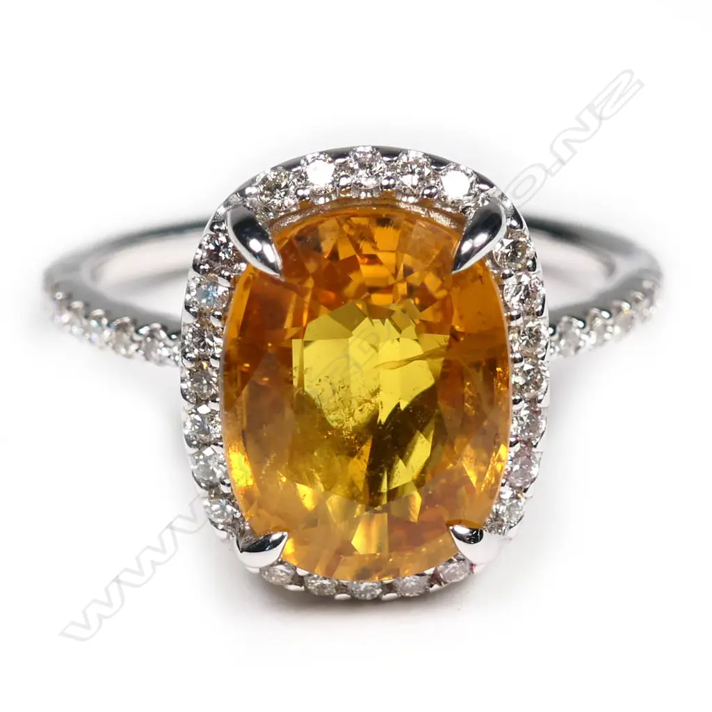 A 14ct white gold, yellow sapphire and diamond halo ring, Image 1++