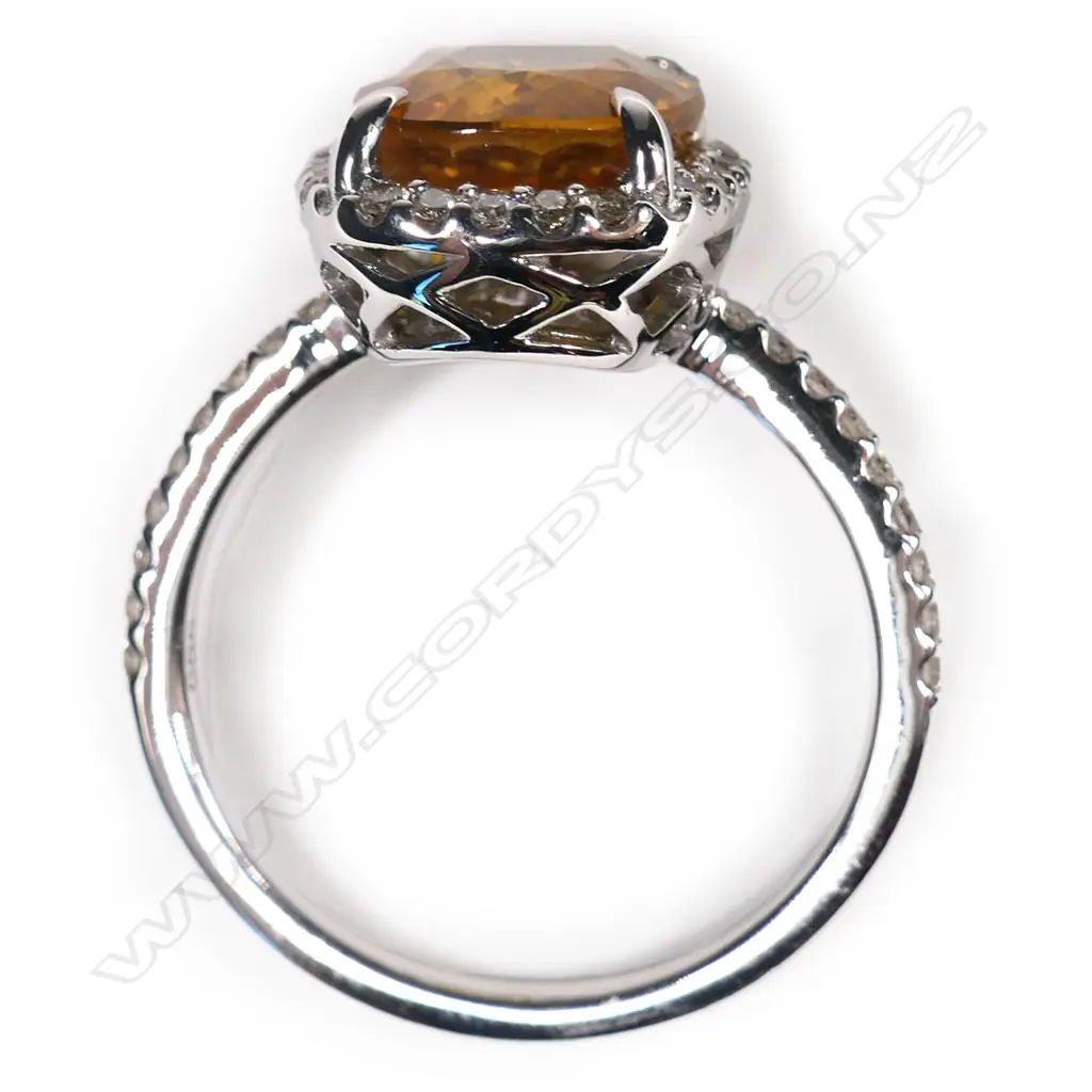 A 14ct white gold, yellow sapphire and diamond halo ring, Image 1++