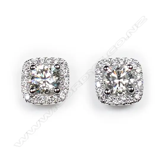 A pair of 18ct white gold and diamond halo stud earrings,
