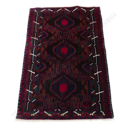 A hand knotted wool pile tribal Balouchi rug,