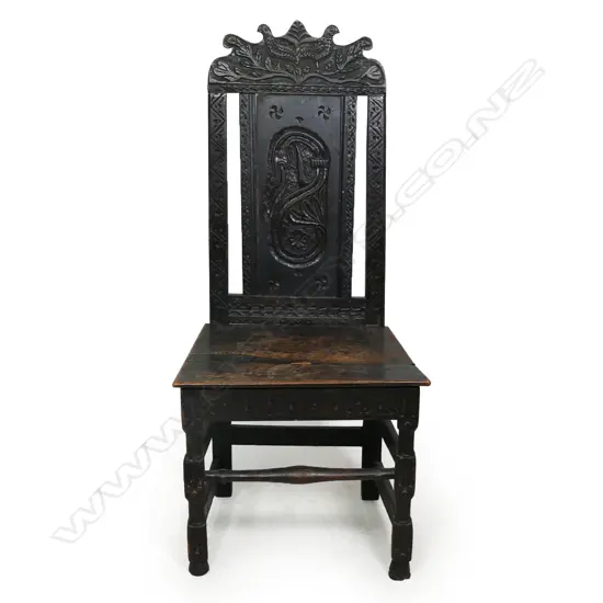 An antique country oak carved chair,