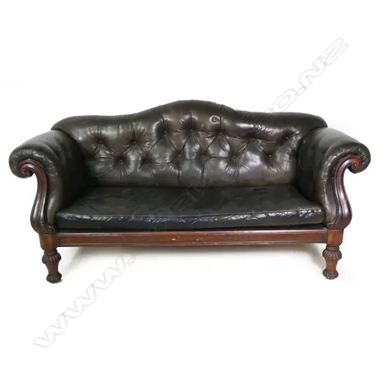 An early Victorian mahogany framed button back leather settee,