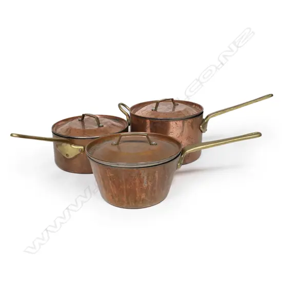 Three St. Clair copper saucepans
