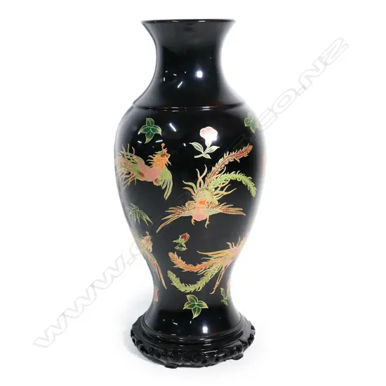 A tall floor standing Chinese black lacquered vase,