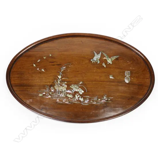 An early 20thC Oriental oval teak tray, inlaid with mother-of-pearl,