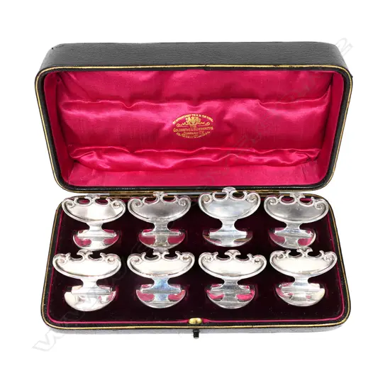 A quality set of eight boxed Edwardian silver name place holders,