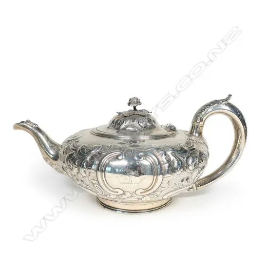 A Victorian silver teapot, with ornate floral repousse decoration,