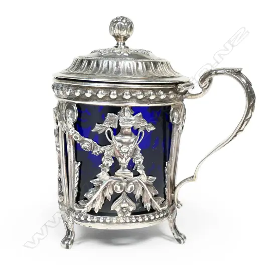 An 18thC French silver mustard pot with blue glass liner,