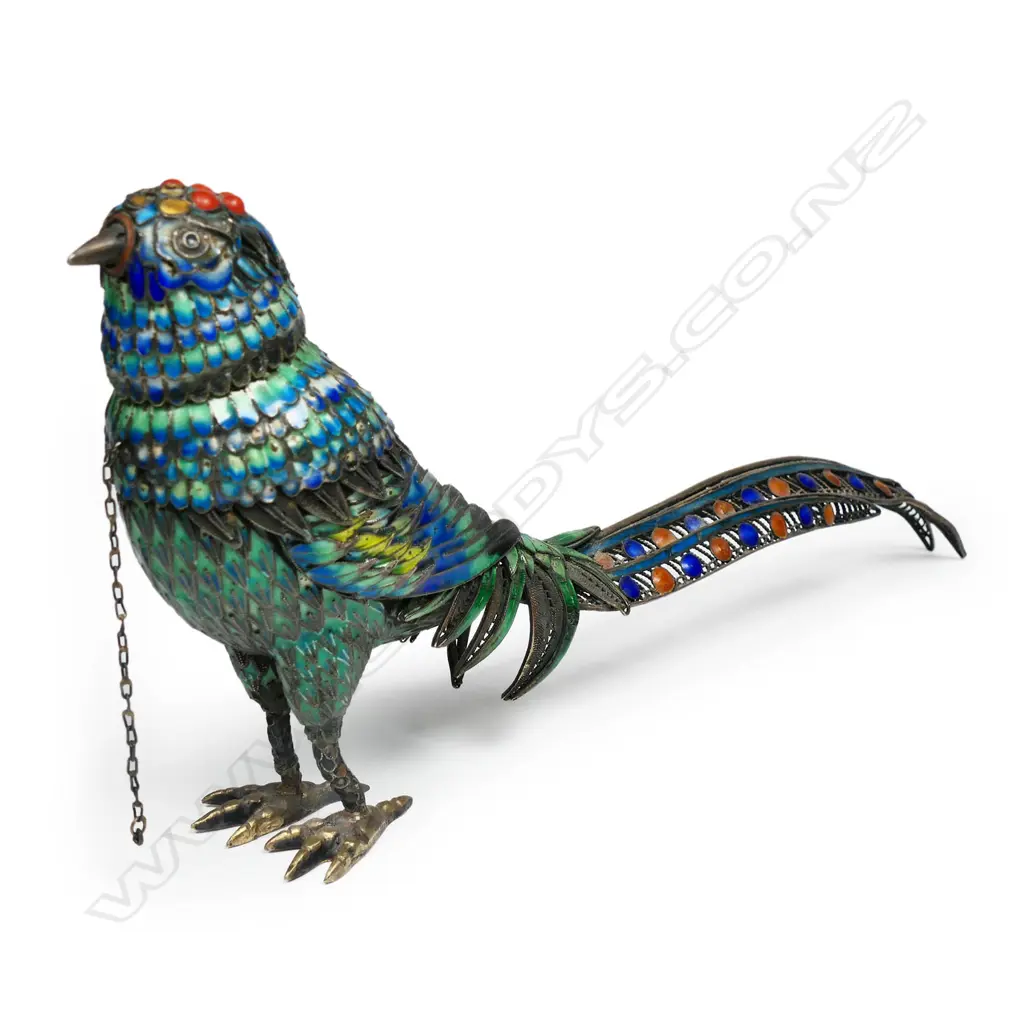 A silver gilt and enamel bird ornament with removeable head revealing the hollow body. Some  cabochons absent and minor enamel losses. Marked 'Silver' to the feet. L.180mm Image 1++