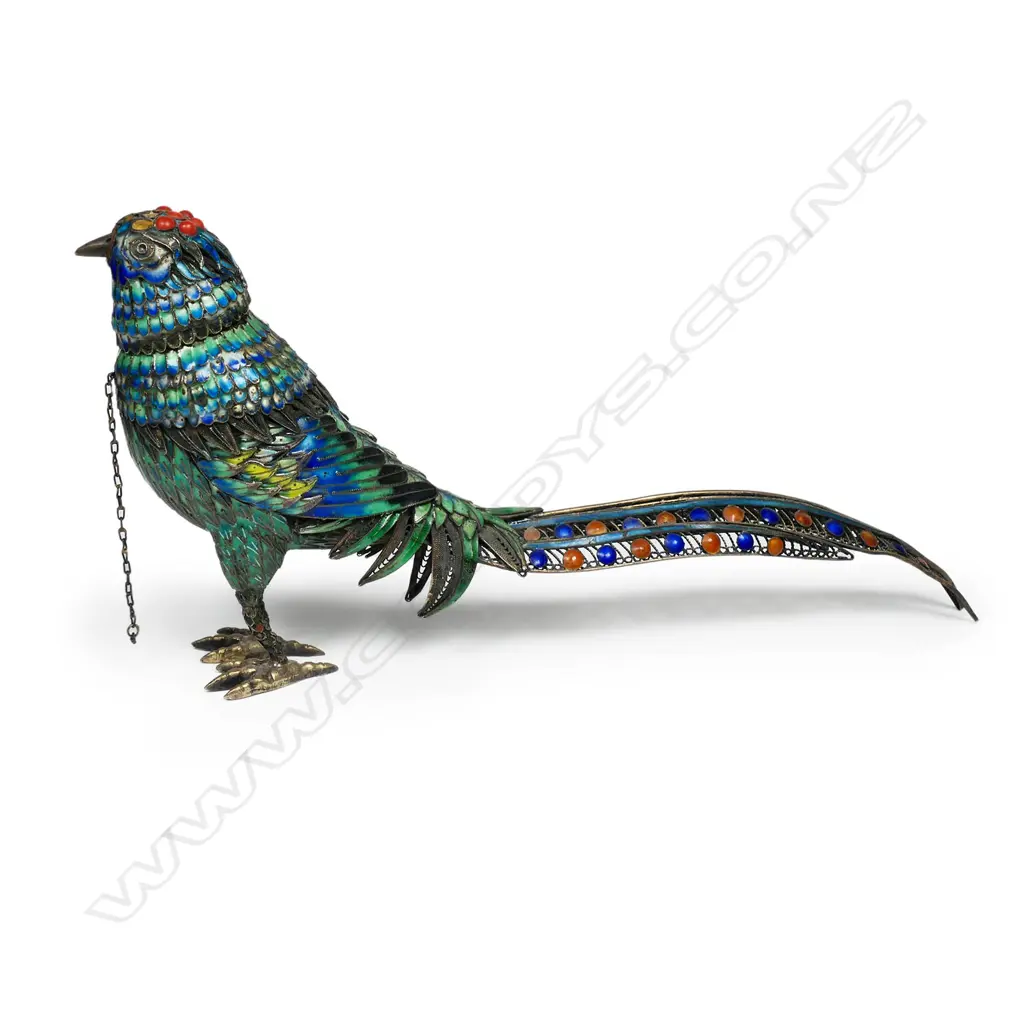 A silver gilt and enamel bird ornament with removeable head revealing the hollow body. Some  cabochons absent and minor enamel losses. Marked 'Silver' to the feet. L.180mm Image 1++