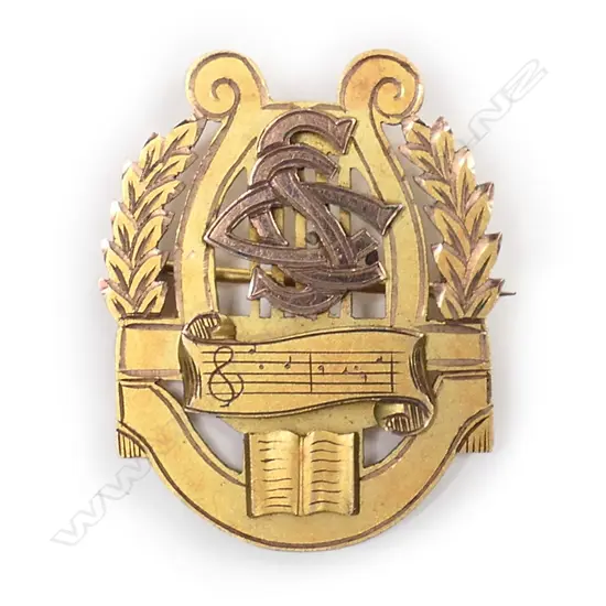 A NZ 1939 Stewart Dawson & Co. 9ct. gilded rose gold music medallion brooch,