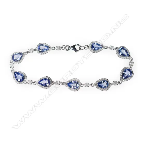 A 14ct white gold, Ceylonese sapphire and diamond halo bracelet,