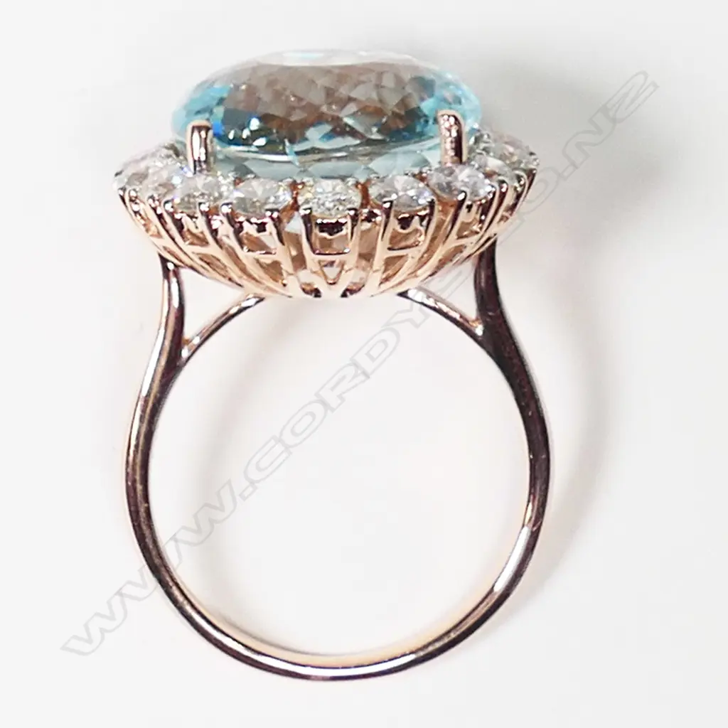 A 14ct white gold aquamarine and diamond halo ring, Image 1++