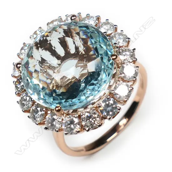 A 14ct white gold aquamarine and diamond halo ring,