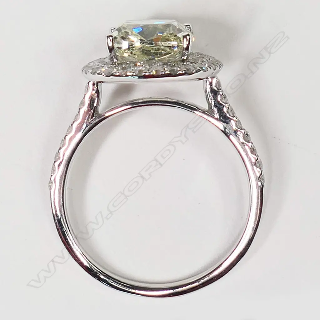 An 18ct white gold and diamond halo ring, Image 1++